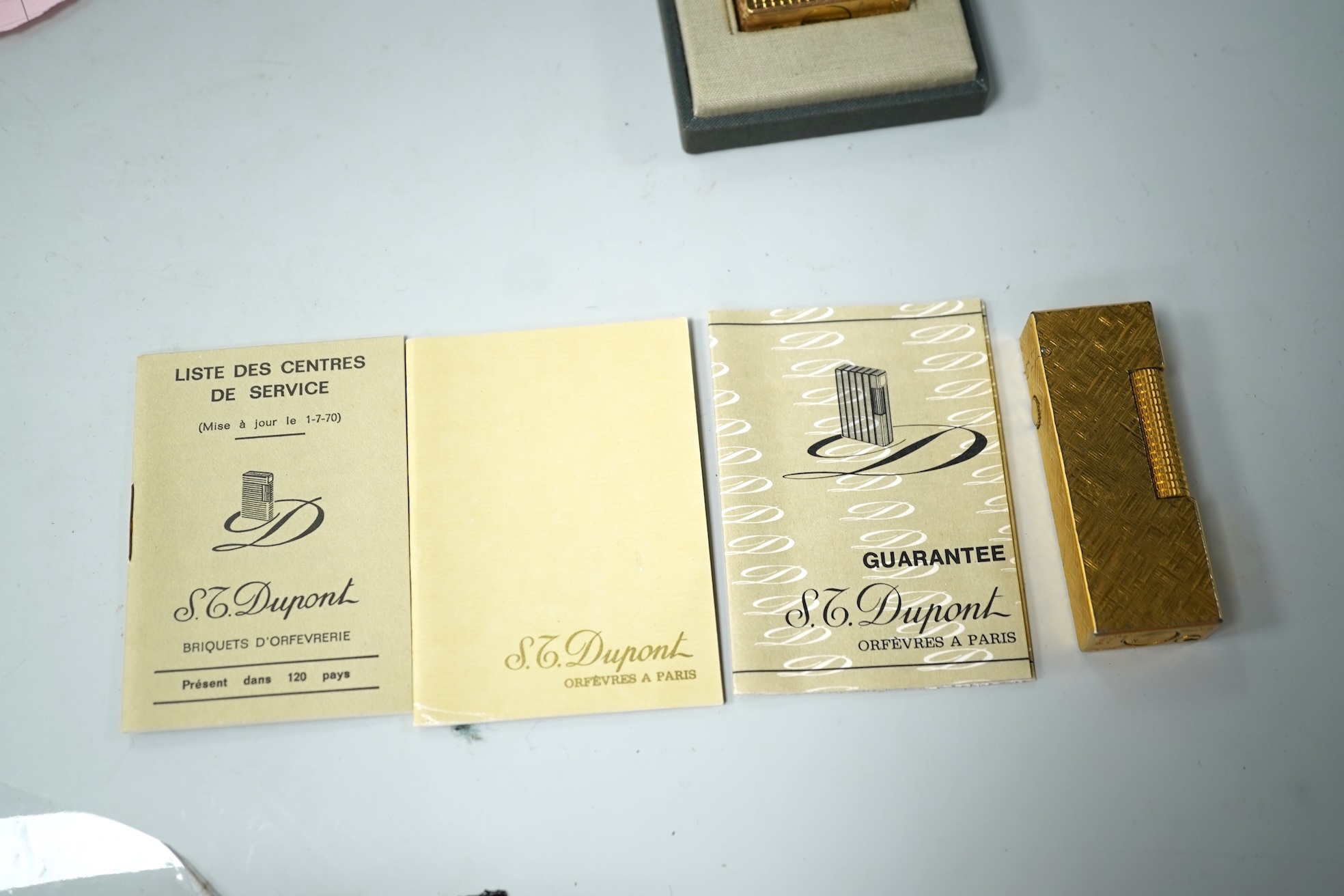 A cased DuPont lighter with booklet and a Dunhill rollagas example
